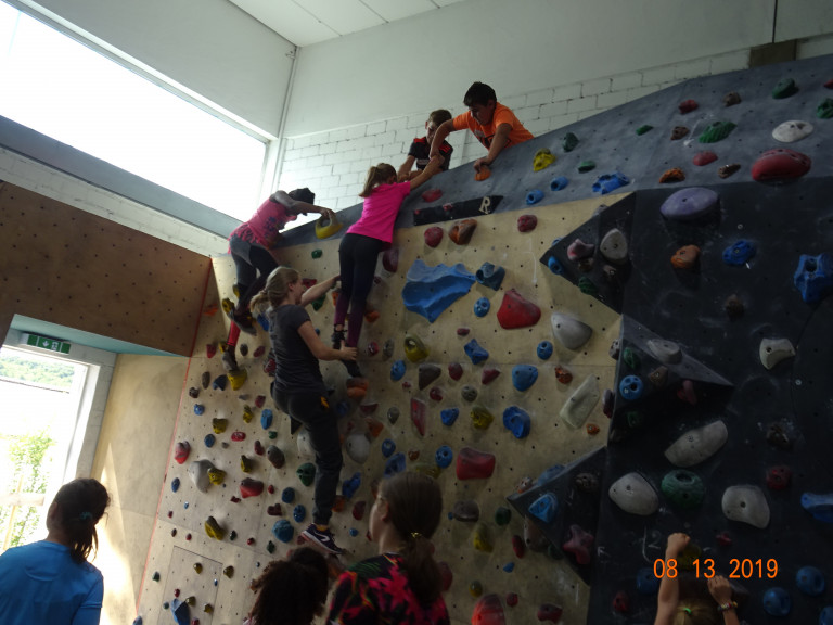 Kinder helfen einander beim Klettern